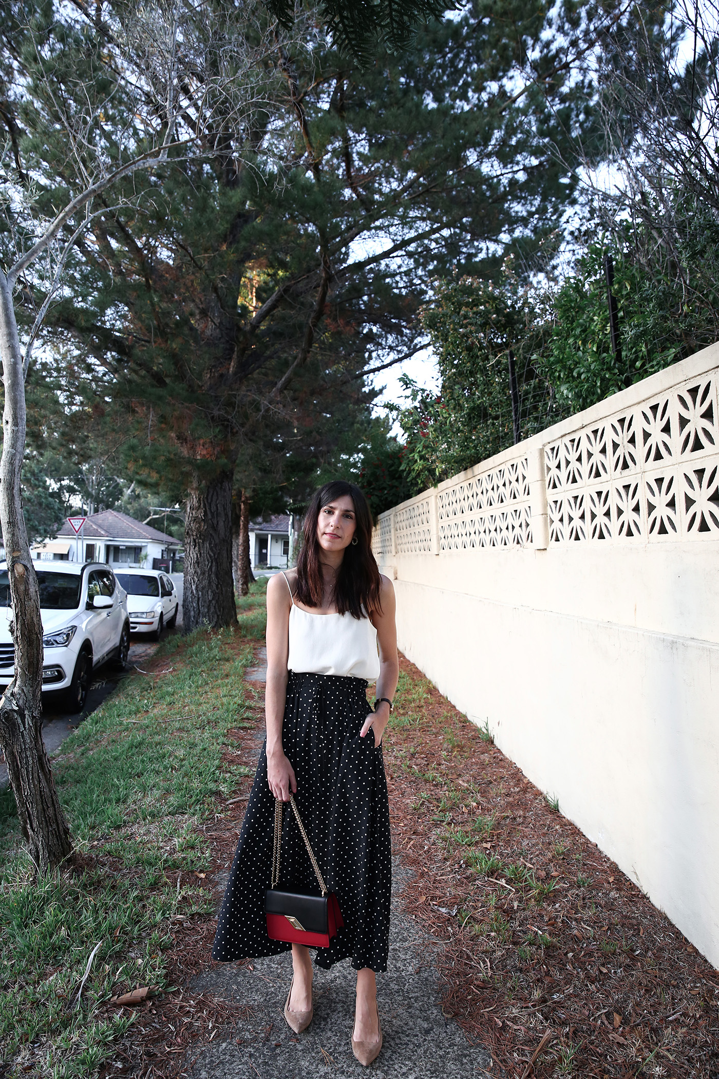 Outfit wearing a silk cami and polka dot skirt Mademoiselle Minimal Style Blog