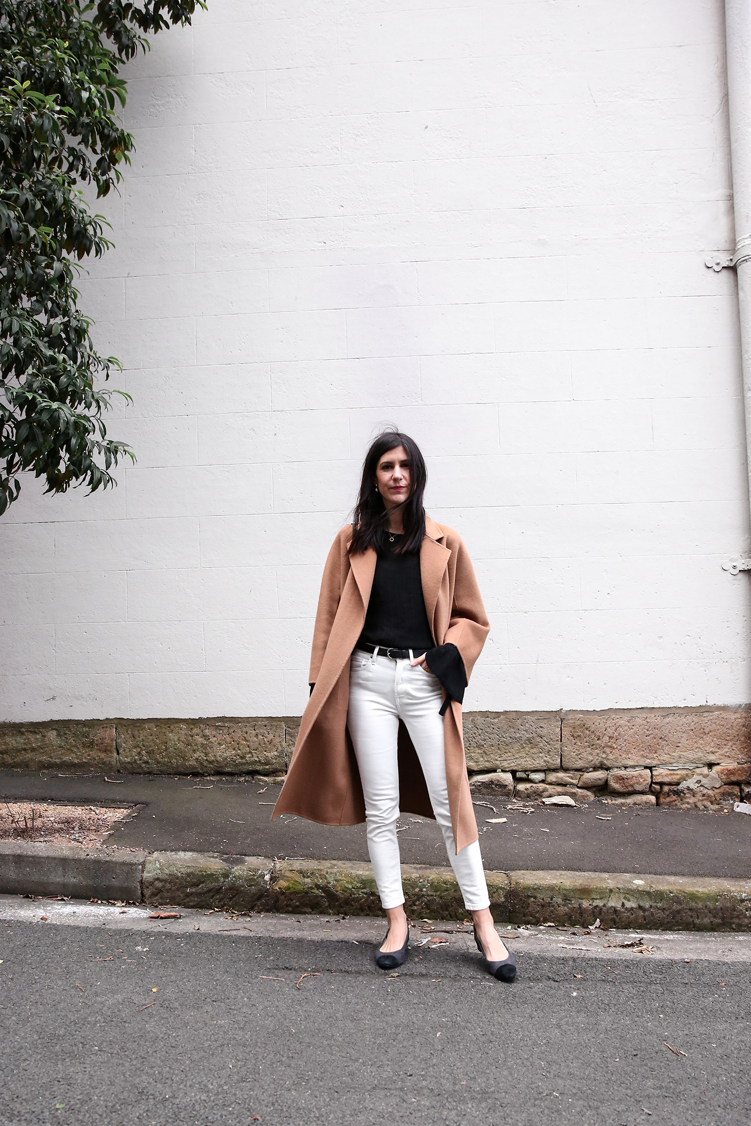 Jamie Lee of Mademoiselle wearing a Scandi style outfit and a The Curated camel wrap coat