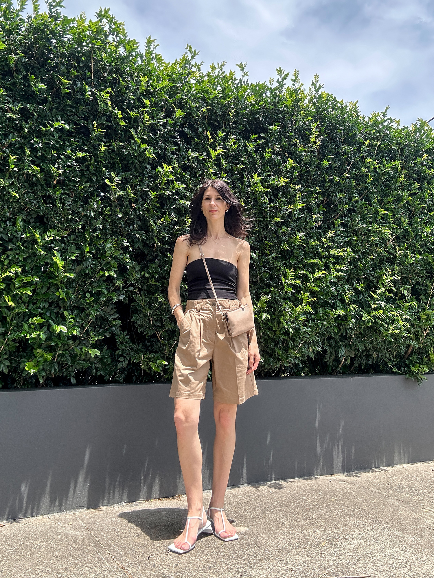 Minimal outfit idea wearing Bermuda shorts and Tibi Georgia sandals