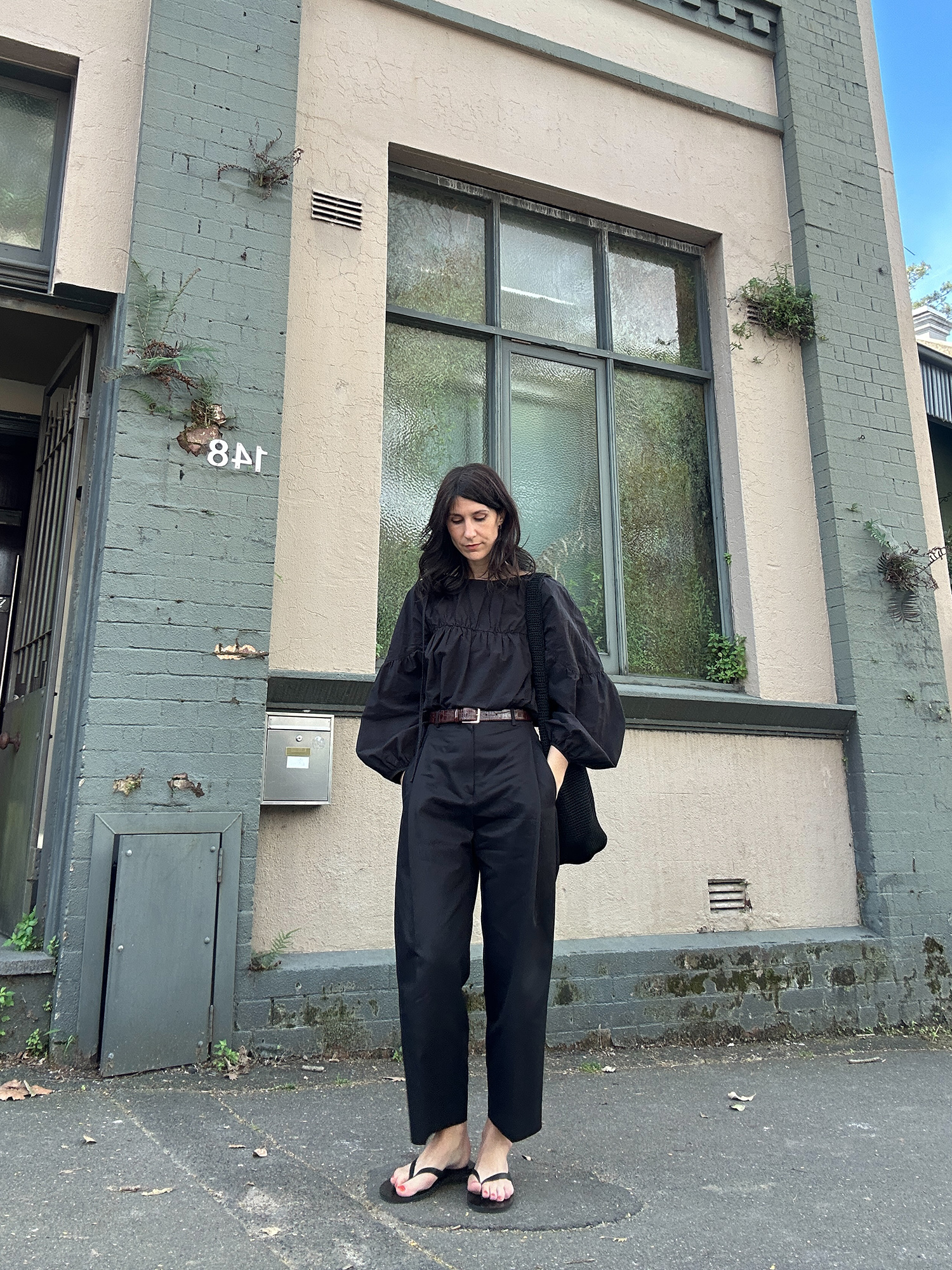 All black outfit wearing Marle Ines top and Facade Pattern round cotton trousers