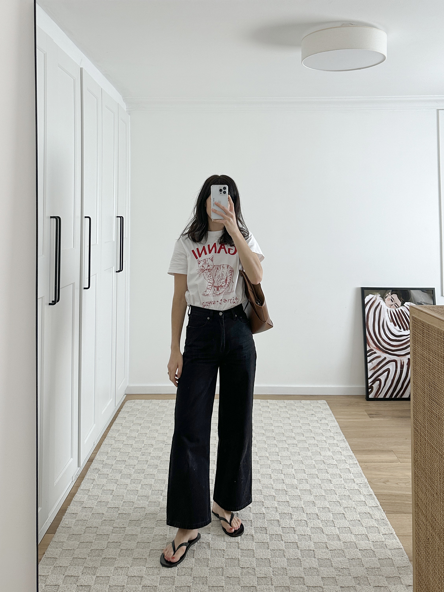 Easy mom outfit idea wearing Ganni t shirt with Alpha60 jeans and Bob Ore bag