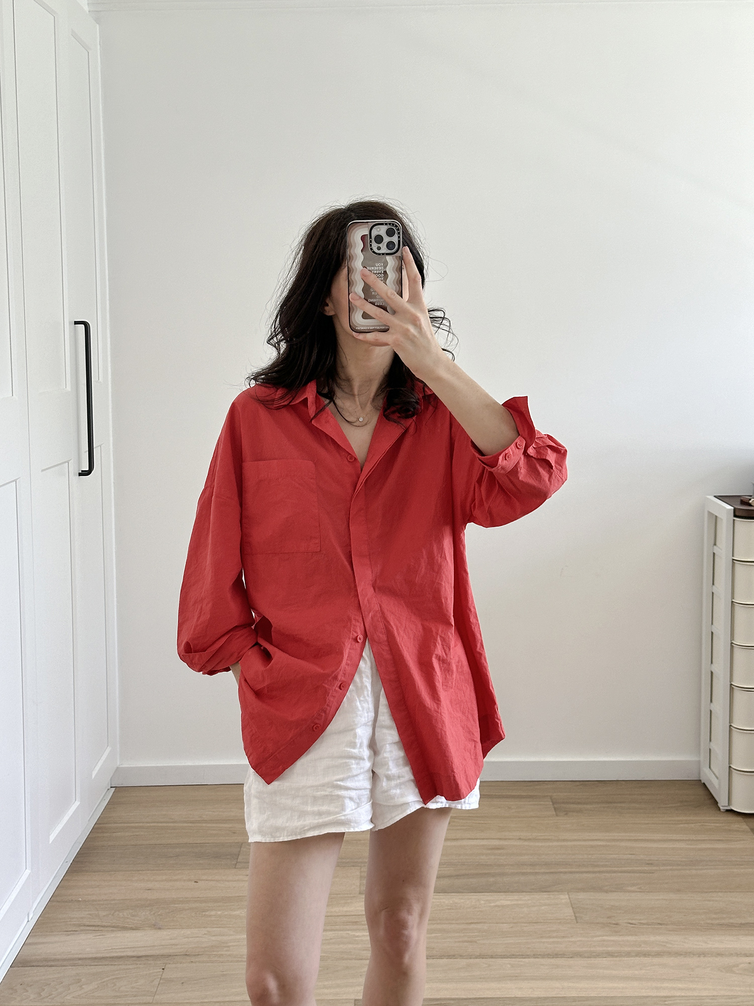 Wearing red oversized shirt with white linen shorts The Row inspired look