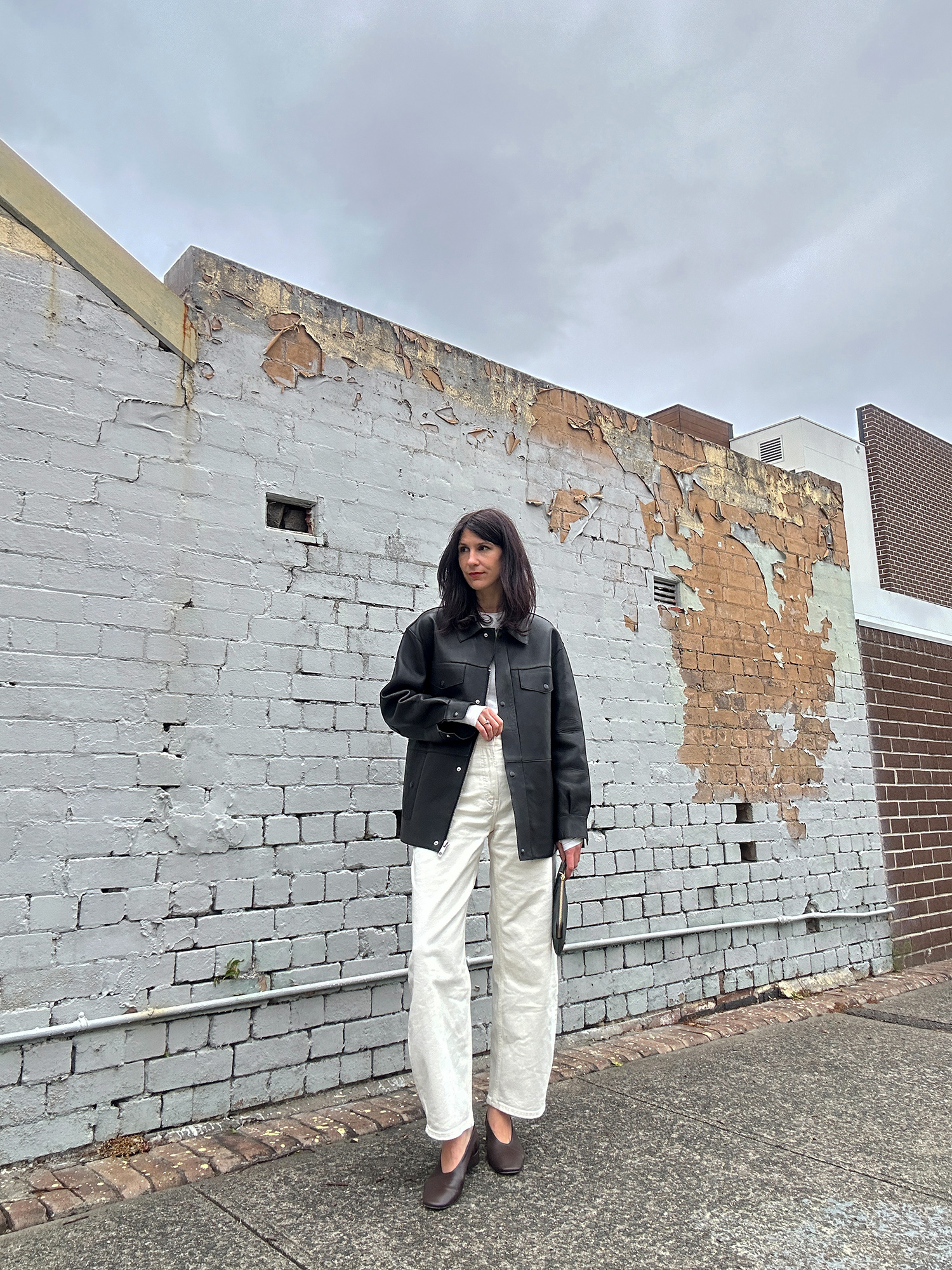 classic minimal autumn outfit wearing everlane barrel leg jeans and leather jacket